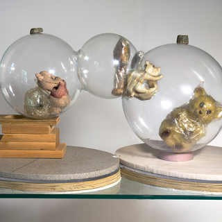 glass globes, plasticine, rubber toys, tape, magnets wood stacks, Corian, plywood, and foam core stacked base 27” x 26” x 14” 